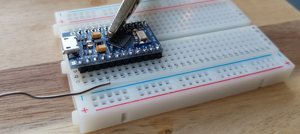 Solder pins to the microcontroller.